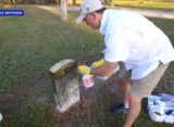 ./.Man honors veterans by cleaning their headstones